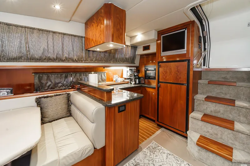 Slide: The Image of Luxurious 2006 Cruisers 415 yacht interior with modern kitchen and cozy seating area. - 20