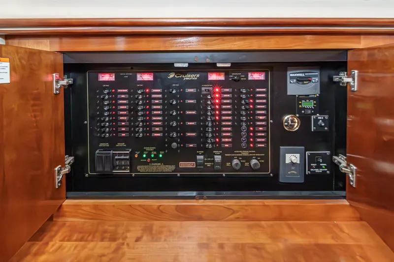 Slide: The Image of Electrical control panel of a 2006 Cruisers 415 yacht, featuring switches and indicators. - 24