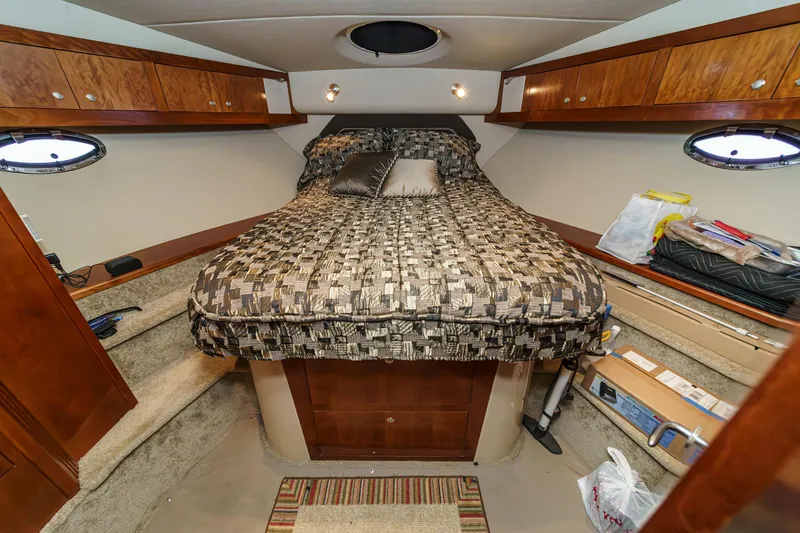 Slide: The Image of Luxurious cabin interior of 2006 Cruisers 415 yacht with cozy bed and wooden storage. - 26