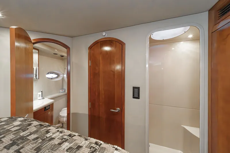 Slide: The Image of Interior of 2006 Cruisers 415 yacht featuring bathroom and wooden doors. - 27