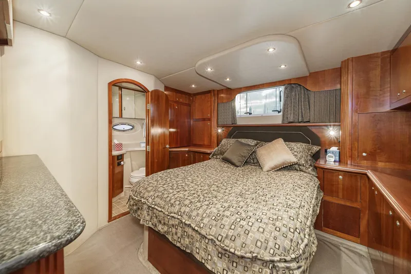 Slide: The Image of Luxurious cabin interior of a 2006 Cruisers 415 yacht with elegant wood finishes. - 30