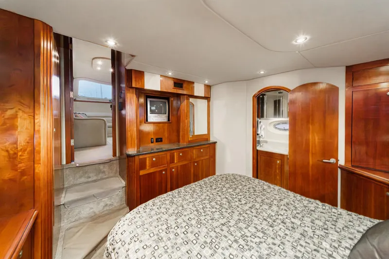 Slide: The Image of Luxurious 2006 Cruisers 415 yacht interior with wood finishes and cozy bedroom. - 31