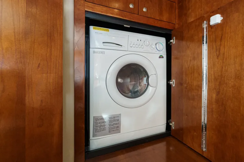 Slide: The Image of Built-in washing machine in wooden cabinet on a 2006 Cruisers 415 yacht. - 33