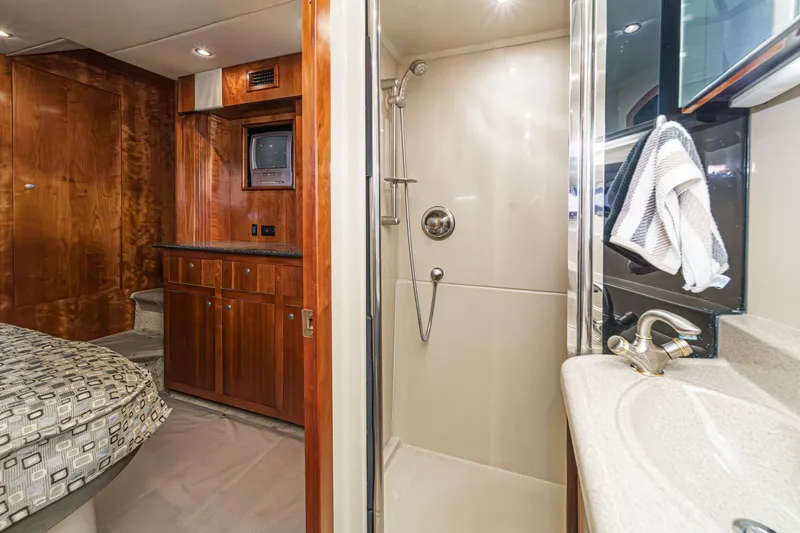 Slide: The Image of Luxurious 2006 Cruisers 415 yacht interior with shower, sink, and wooden cabinetry. - 34