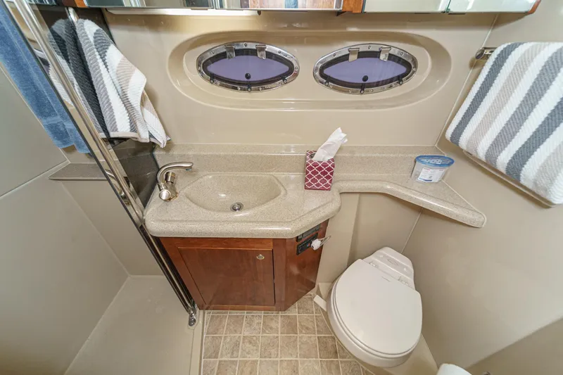 Slide: The Image of Luxurious bathroom in 2006 Cruisers 415 yacht with sink, toilet, and porthole windows. - 35