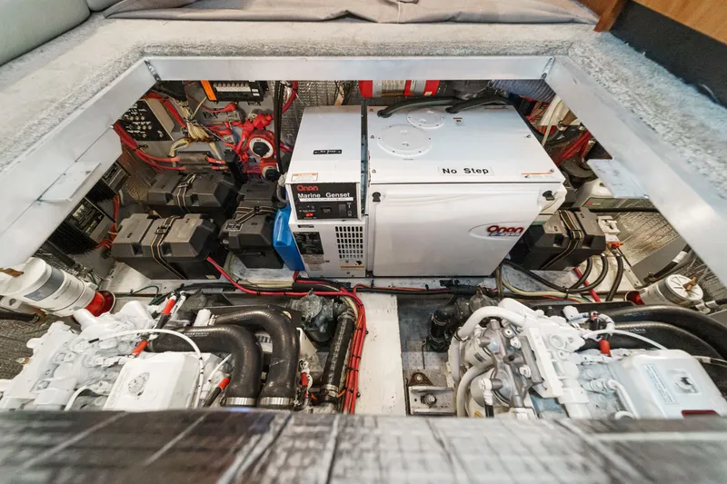 Slide: The Image of Engine room of a 2006 Cruisers 415 yacht, featuring a generator and mechanical components. - 37