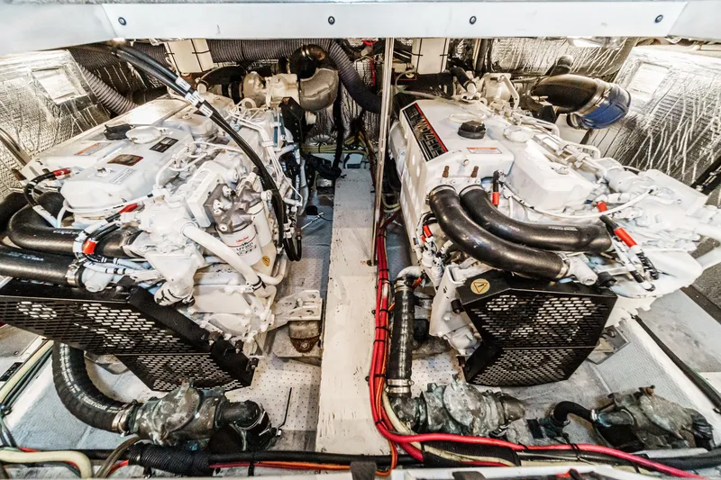 Slide: The Image of Engine room of 2006 Cruisers 415 yacht, featuring dual engines and complex piping system. - 38
