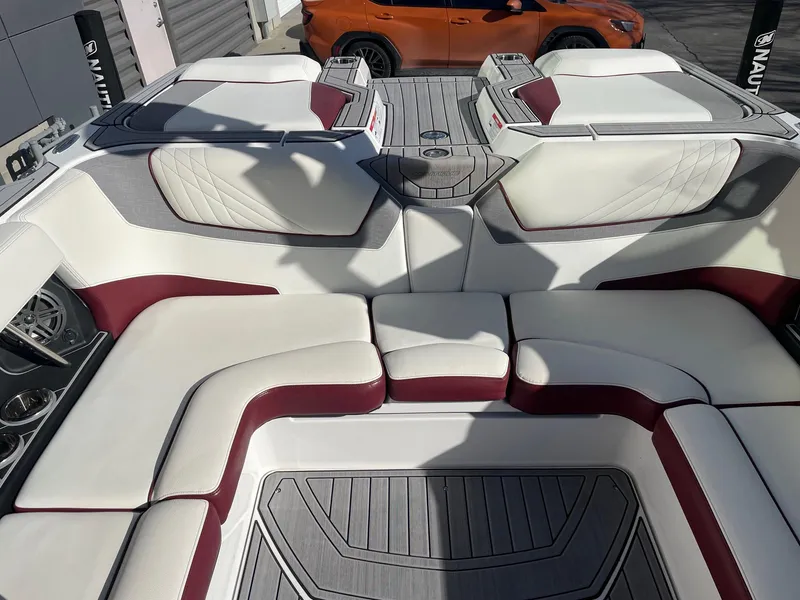 Slide: The Image of 2022 Nautique Super Air Nautique GS22 interior with white and maroon seating. - 10