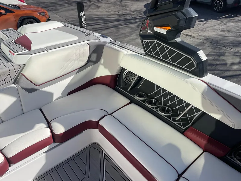 Slide: The Image of 2022 Nautique Super Air Nautique GS22 interior with white and maroon seating. - 11