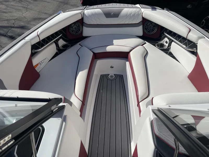 Slide: The Image of 2022 Nautique Super Air Nautique GS22 interior with white and maroon seating. - 13