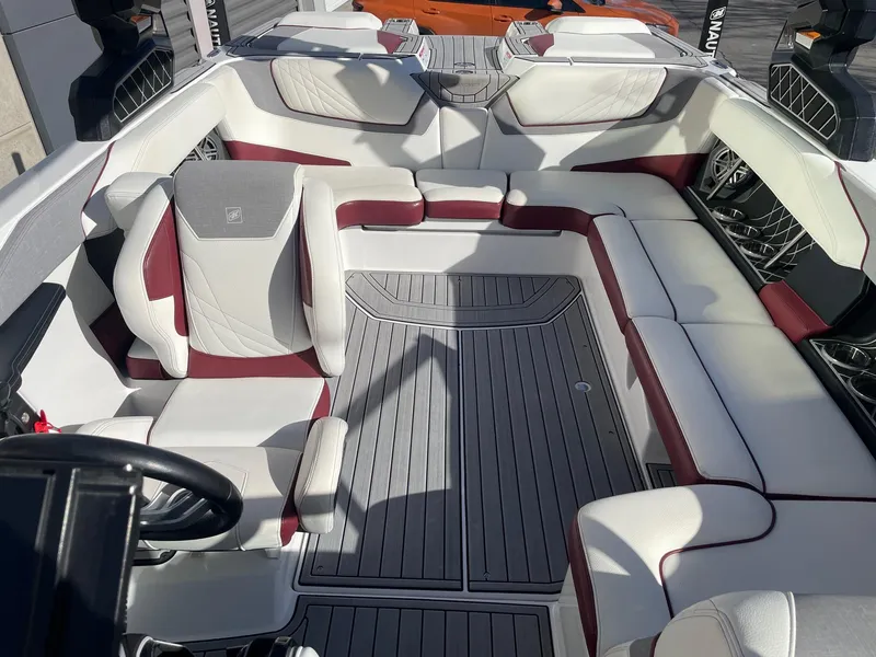 Slide: The Image of 2022 Nautique Super Air Nautique GS22 interior with white and maroon seating. - 14
