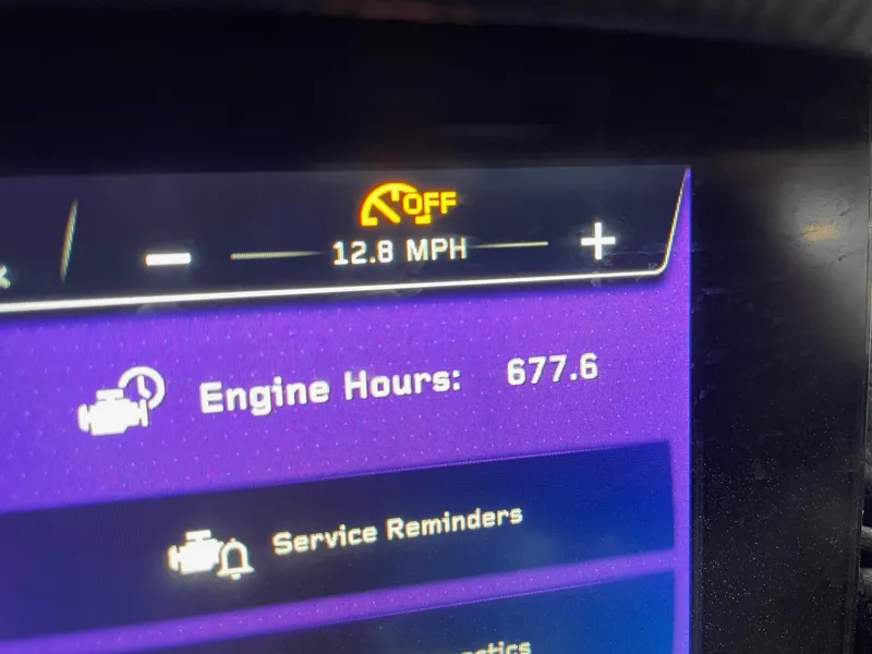 Slide: The Image of Dashboard display of 2022 Nautique Super Air Nautique GS22 showing 12.8 MPH and 677.6 engine hours. - 15