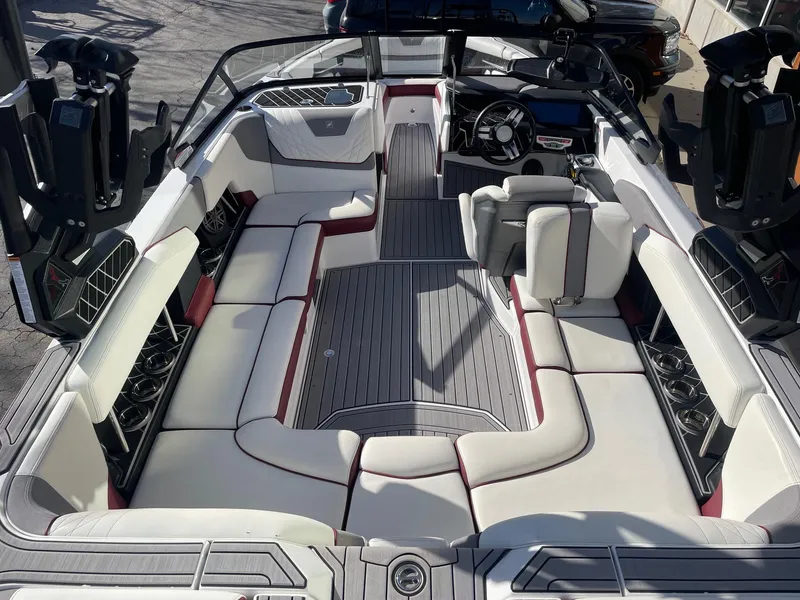 Slide: The Image of 2022 Nautique Super Air Nautique GS22 interior with luxurious seating and modern dashboard. - 7
