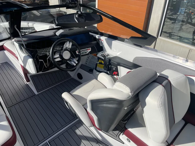 Slide: The Image of 2022 Nautique Super Air Nautique GS22 interior with modern dashboard and seating. - 8