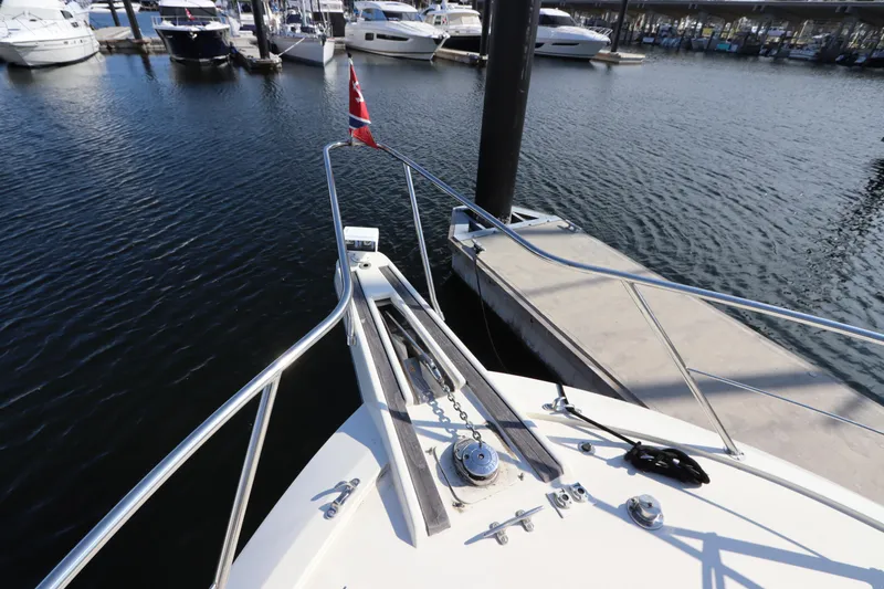 Slide: The Image of Bow view of 1990 Hatteras 40 Double Cabin docked at marina. - 10