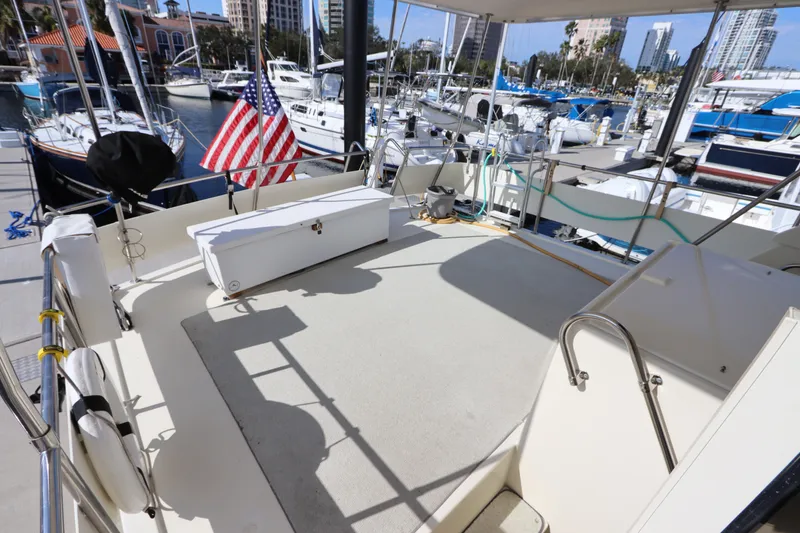 Slide: The Image of 1990 Hatteras 40 Double Cabin yacht deck with marina view and American flag. - 12