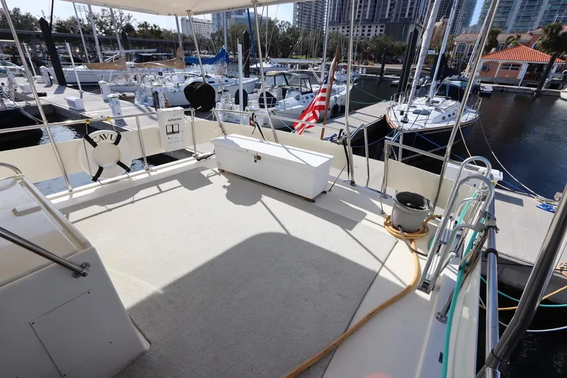 Slide: The Image of 1990 Hatteras 40 Double Cabin yacht deck at marina with American flag. - 13