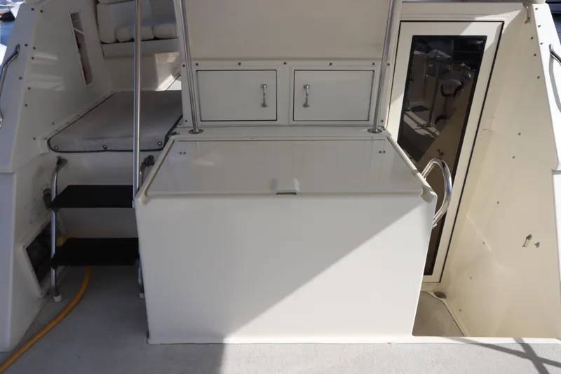 Slide: The Image of 1990 Hatteras 40 Double Cabin yacht interior with storage compartments and seating area. - 15