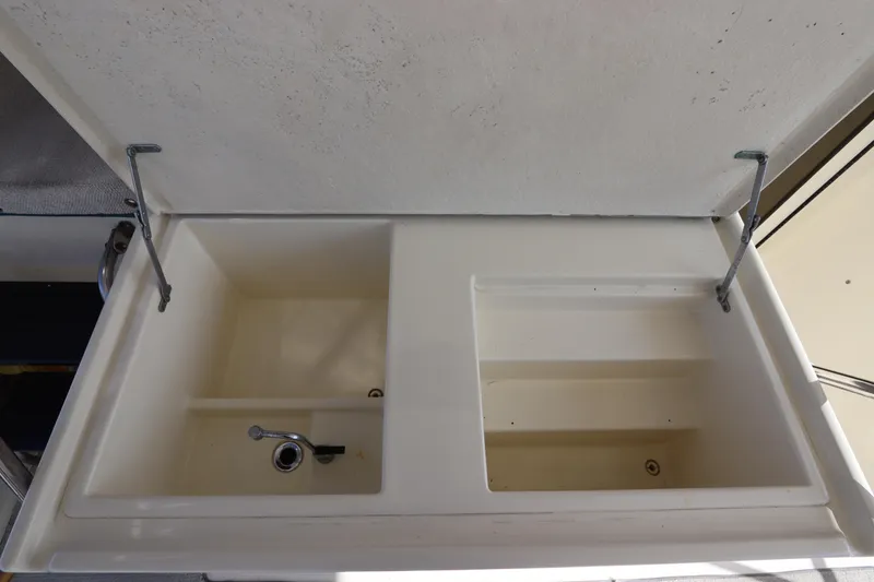 Slide: The Image of Hatteras 40 Double Cabin 1990 boat sink with dual compartments and open lid. - 16