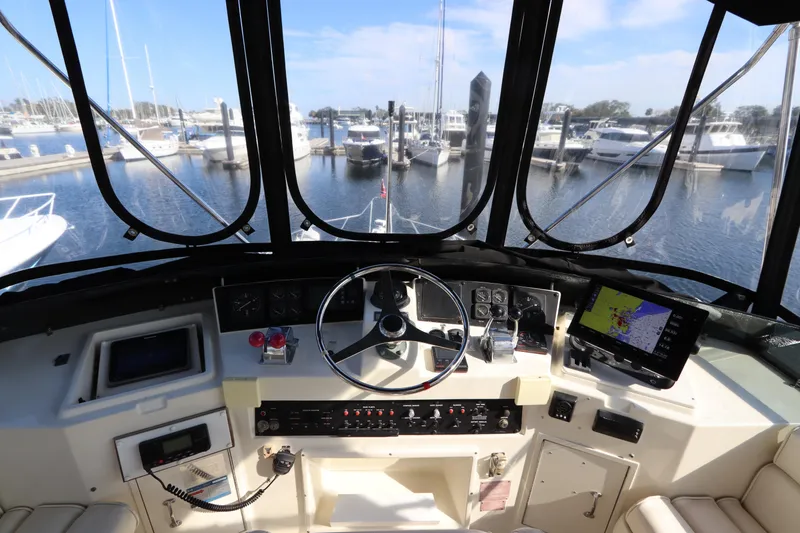 Slide: The Image of Cockpit view of 1990 Hatteras 40 Double Cabin yacht at marina. - 22