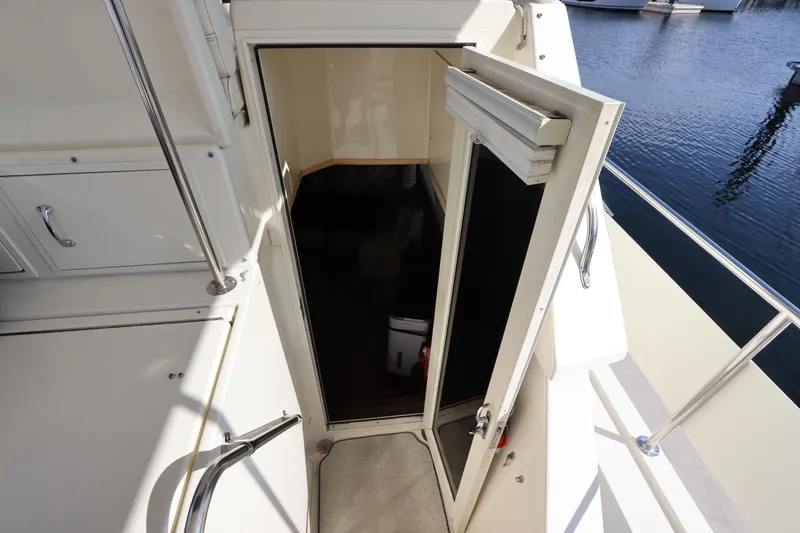 Slide: The Image of 1990 Hatteras 40 Double Cabin yacht entrance with open door, dockside view. - 30