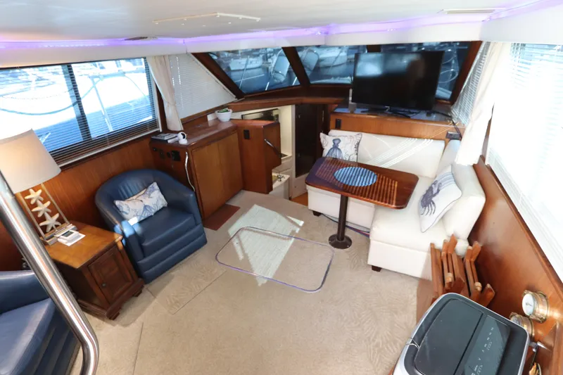 Slide: The Image of Interior of 1990 Hatteras 40 Double Cabin with cozy seating and modern amenities. - 31