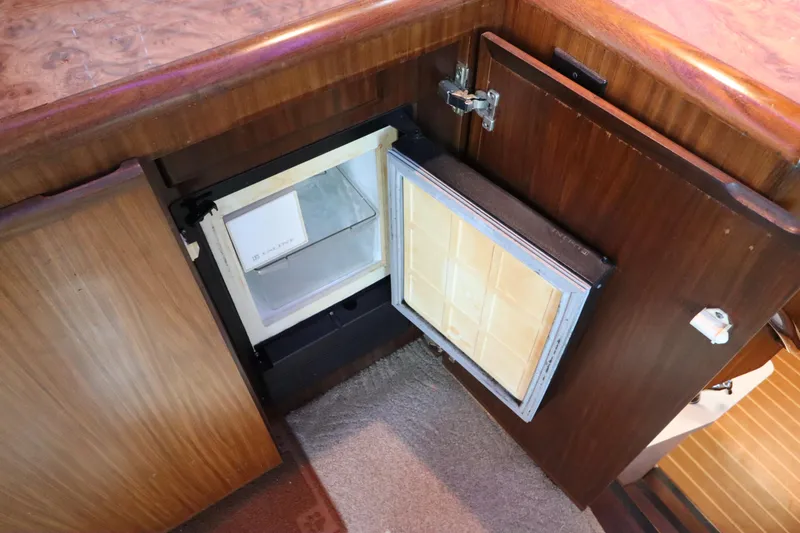 Slide: The Image of 1990 Hatteras 40 Double Cabin interior with open mini fridge. - 34