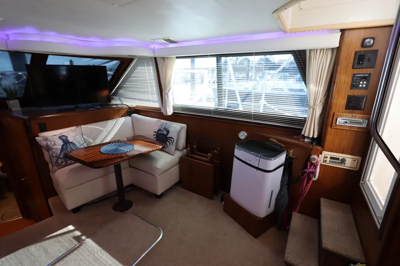 Slide: The Image of Interior of 1990 Hatteras 40 Double Cabin with seating, table, and TV. - 35
