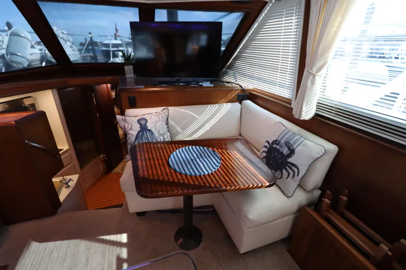 Slide: The Image of Interior of 1990 Hatteras 40 Double Cabin with cozy seating and nautical decor. - 36