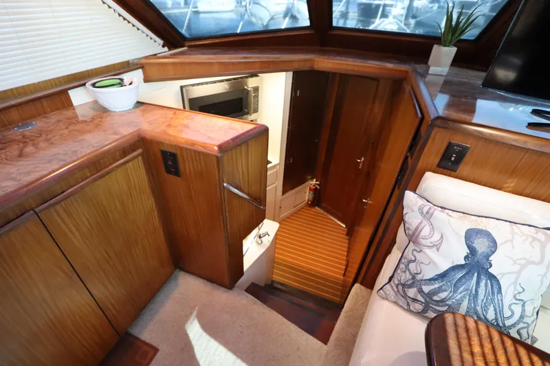 Slide: The Image of Interior of 1990 Hatteras 40 Double Cabin with wood finish and octopus pillow. - 37