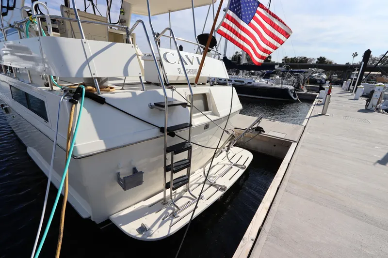 Slide: The Image of 1990 Hatteras 40 Double Cabin yacht docked with American flag. - 4