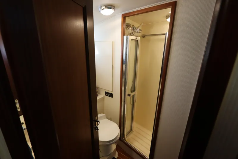 Slide: The Image of Bathroom interior of 1990 Hatteras 40 Double Cabin yacht, featuring shower and toilet. - 42