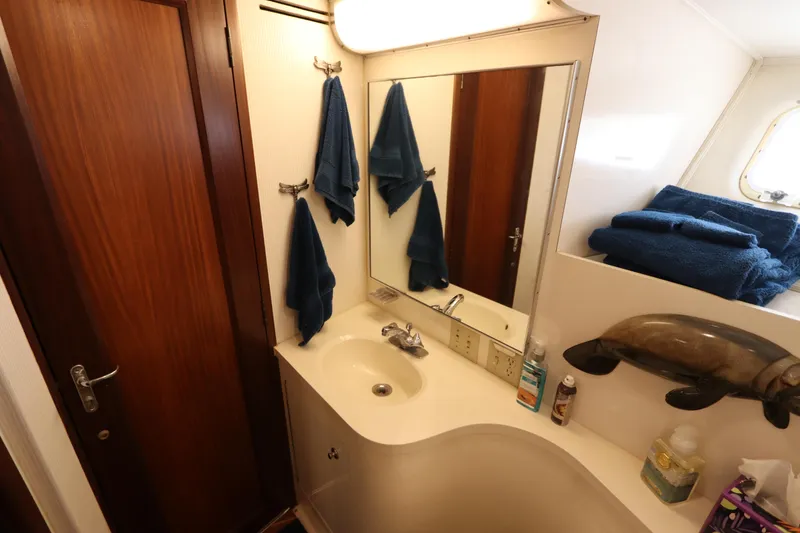 Slide: The Image of Bathroom interior of 1990 Hatteras 40 Double Cabin with mirror and towels. - 43
