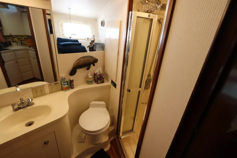 Slide: The Image of 1990 Hatteras 40 Double Cabin bathroom with shower, sink, and toilet. - 44