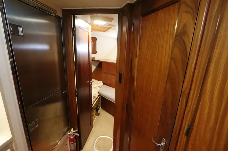 Slide: The Image of Interior of 1990 Hatteras 40 Double Cabin with wooden doors and cozy cabin space. - 45