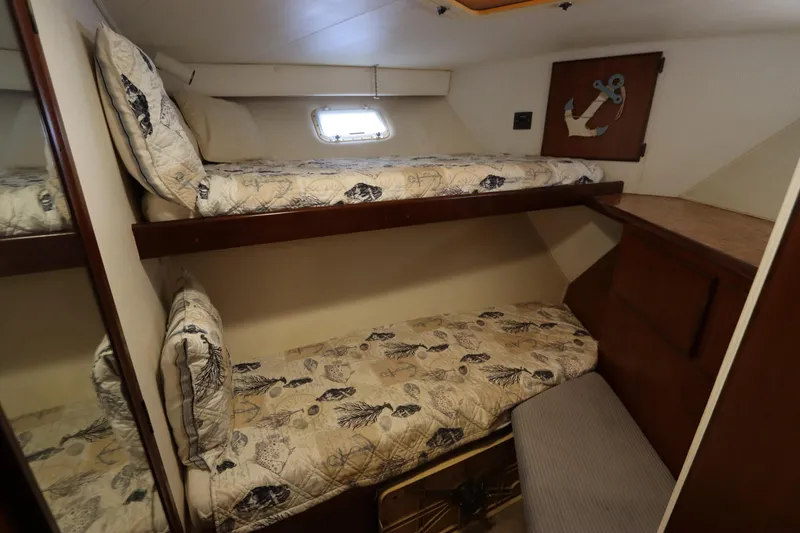 Slide: The Image of 1990 Hatteras 40 Double Cabin interior with bunk beds and nautical decor. - 47