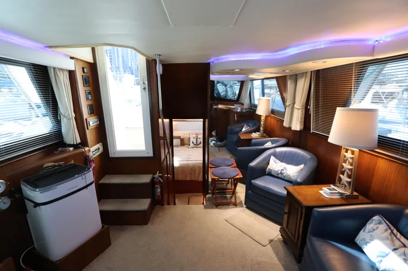 Slide: The Image of Interior of 1990 Hatteras 40 Double Cabin yacht with cozy seating and ambient lighting. - 48