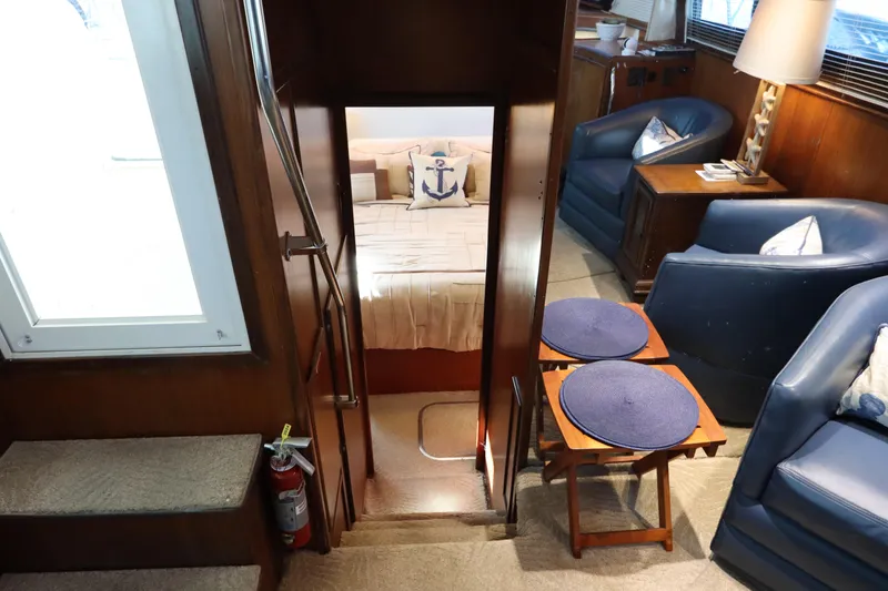 Slide: The Image of Interior of 1990 Hatteras 40 Double Cabin with cozy seating and nautical decor. - 49