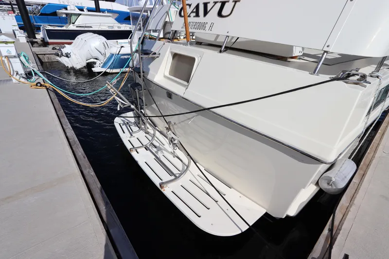 Slide: The Image of 1990 Hatteras 40 Double Cabin yacht docked with swim platform visible. - 5