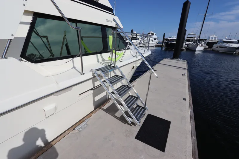 Slide: The Image of 1990 Hatteras 40 Double Cabin yacht docked with metal boarding stairs. - 8