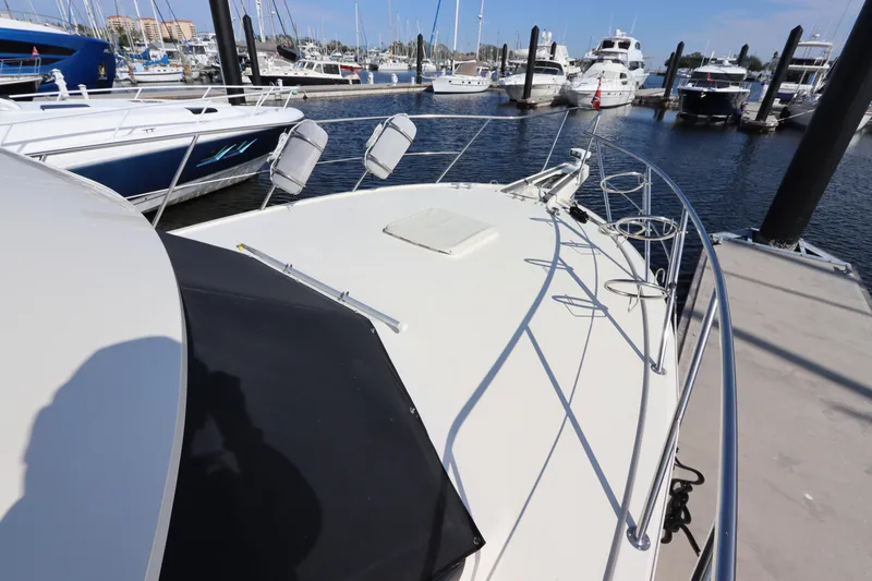 Slide: The Image of 1990 Hatteras 40 Double Cabin yacht docked at marina, view of bow and deck. - 9