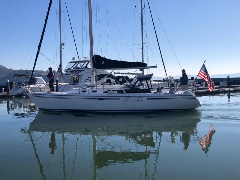 Slide: The Image of 2006 Catalina 36 MkII sailboat on calm water with American flag. - 0
