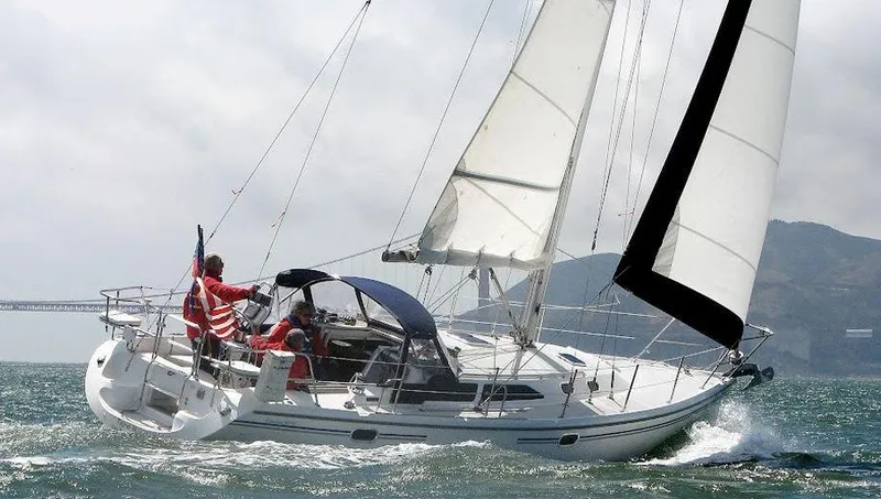 Slide: The Image of 2006 Catalina 36 MkII sailboat navigating choppy waters with crew onboard. - 12