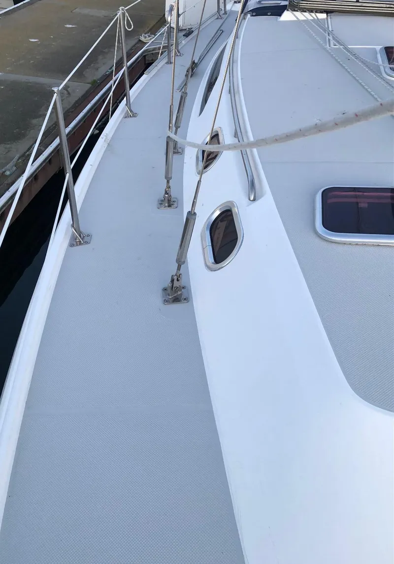 Slide: The Image of 2006 Catalina 36 MkII sailboat deck with stainless steel railings and hatches. - 14