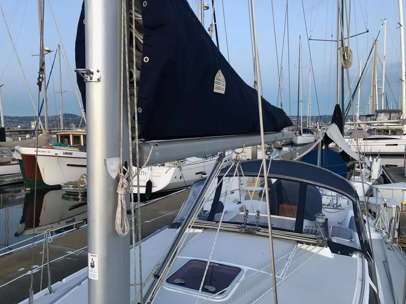 Slide: The Image of 2006 Catalina 36 MkII sailboat docked in marina, featuring mast and cockpit view. - 16