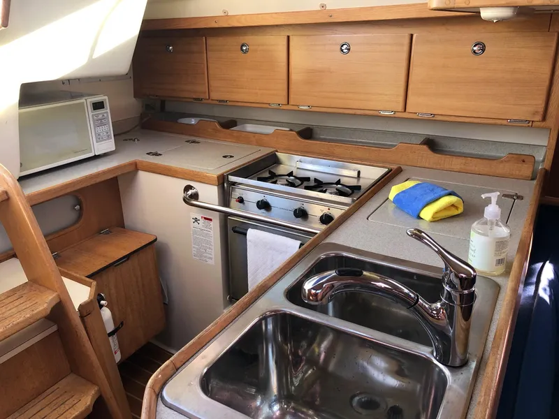 Slide: The Image of Interior of 2006 Catalina 36 MkII yacht kitchen with stove, sink, and microwave. - 4