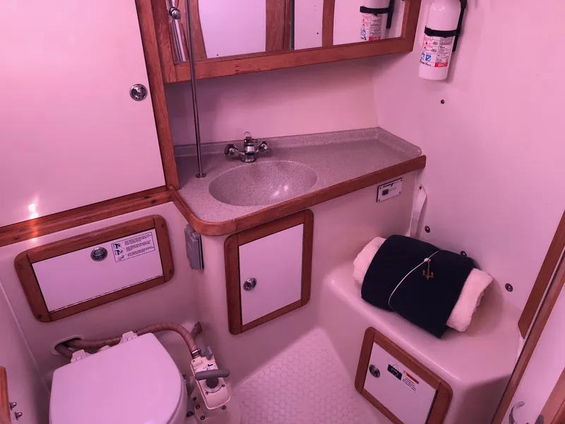 Slide: The Image of 2006 Catalina 36 MkII yacht bathroom with sink, toilet, and storage cabinets. - 7