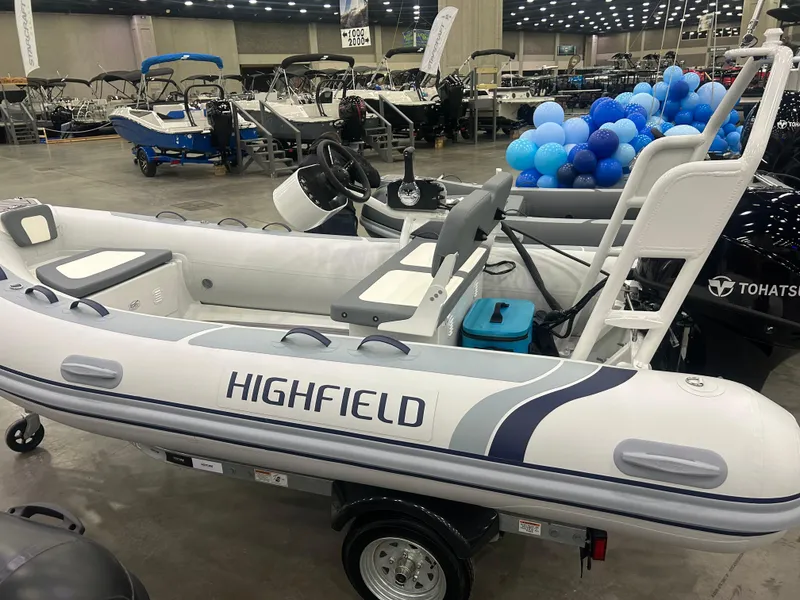 Slide: The Image of 2025 Highfield Classic 400 inflatable boat displayed at an indoor boat show. - 0