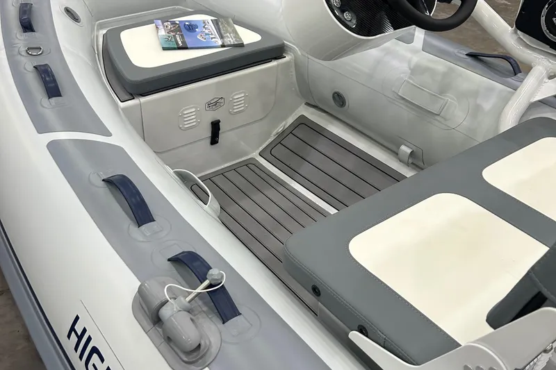 Slide: The Image of 2025 Highfield Classic 400 boat interior with seating and storage compartments. - 1
