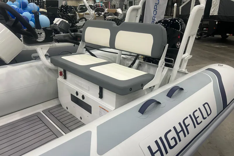 Slide: The Image of 2025 Highfield Classic 400 boat interior with seating and branding. - 2